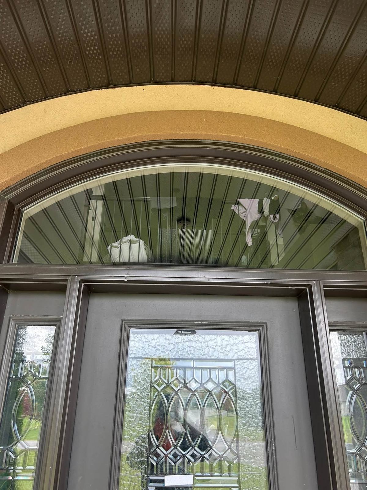 Same arched window spotless and clear after cleaning