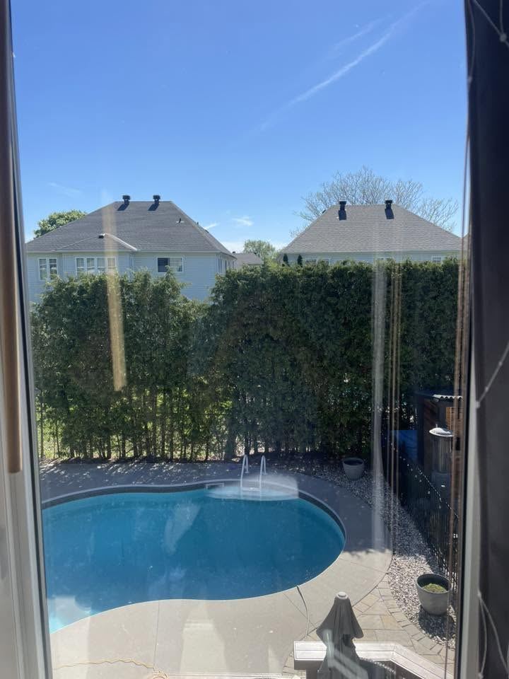 Crystal-clear window overlooking the same pool after cleaning