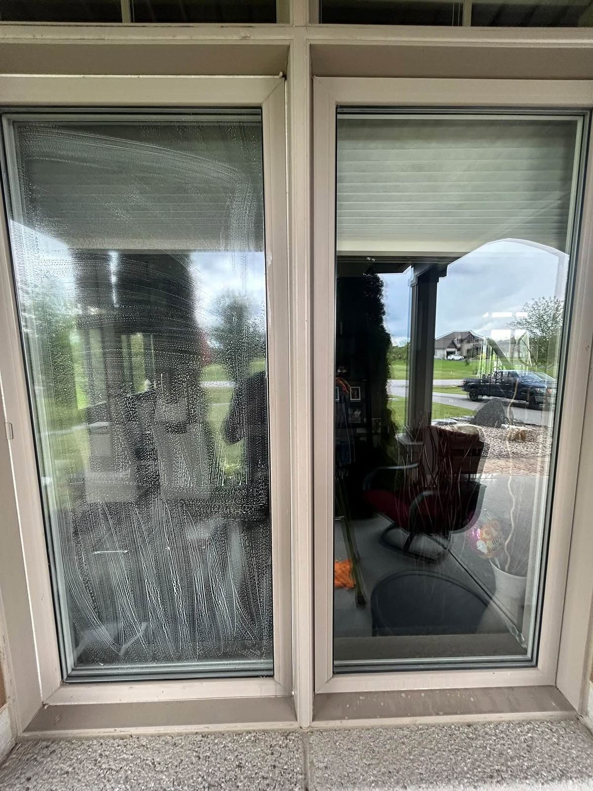 One window pane still hazy next to a freshly cleaned pane, side by side